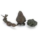 Three Japanese patinated bronze vegetables and fruits, each with impressed marks, the largest 8cm in