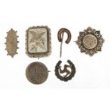 Five Victorian silver brooches including some aesthetic and Isle of Man, the largest 3.5cm wide,