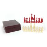 Half stained carved bone chess set, the largest pieces 12cm high