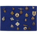 Twenty British military badges including Royal Sussex and Cinq Ports brooches including enamel and