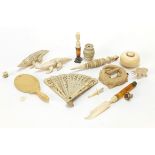 Antique and later carved ivory and bone objects including a fan, animals and desk seal, the