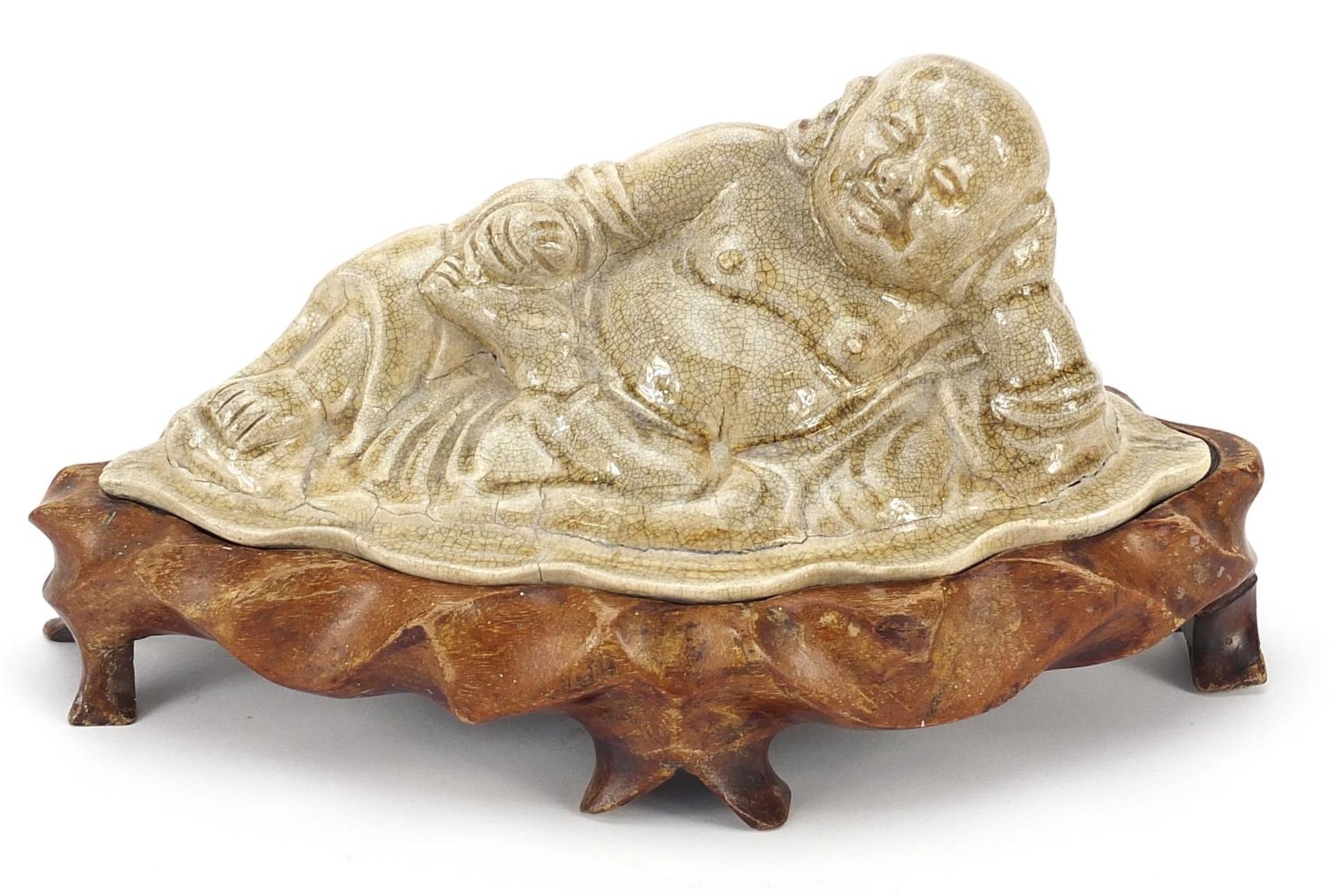 Chinese pottery figure of Buddha on a lotus flower having a grey crackle glaze, raised on a carved