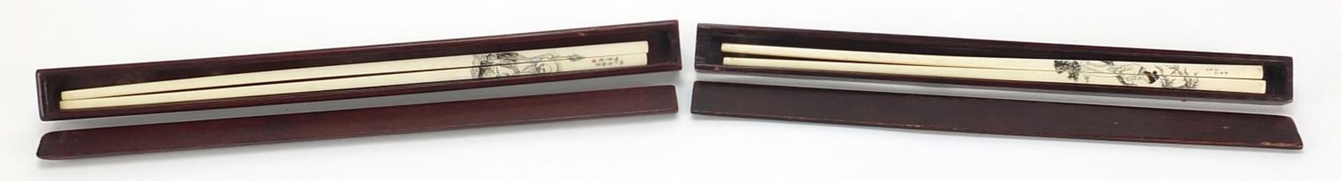 Two pairs of Chinese chop sticks with hardwood cases, the cases 30cm in length