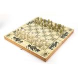 Aztec design folding games board with carved onyx chess set, the largest pieces 5.5cm high, the