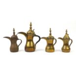 Four Imani brass dallah coffee pots, some with impressed marks, the largest 39cm high