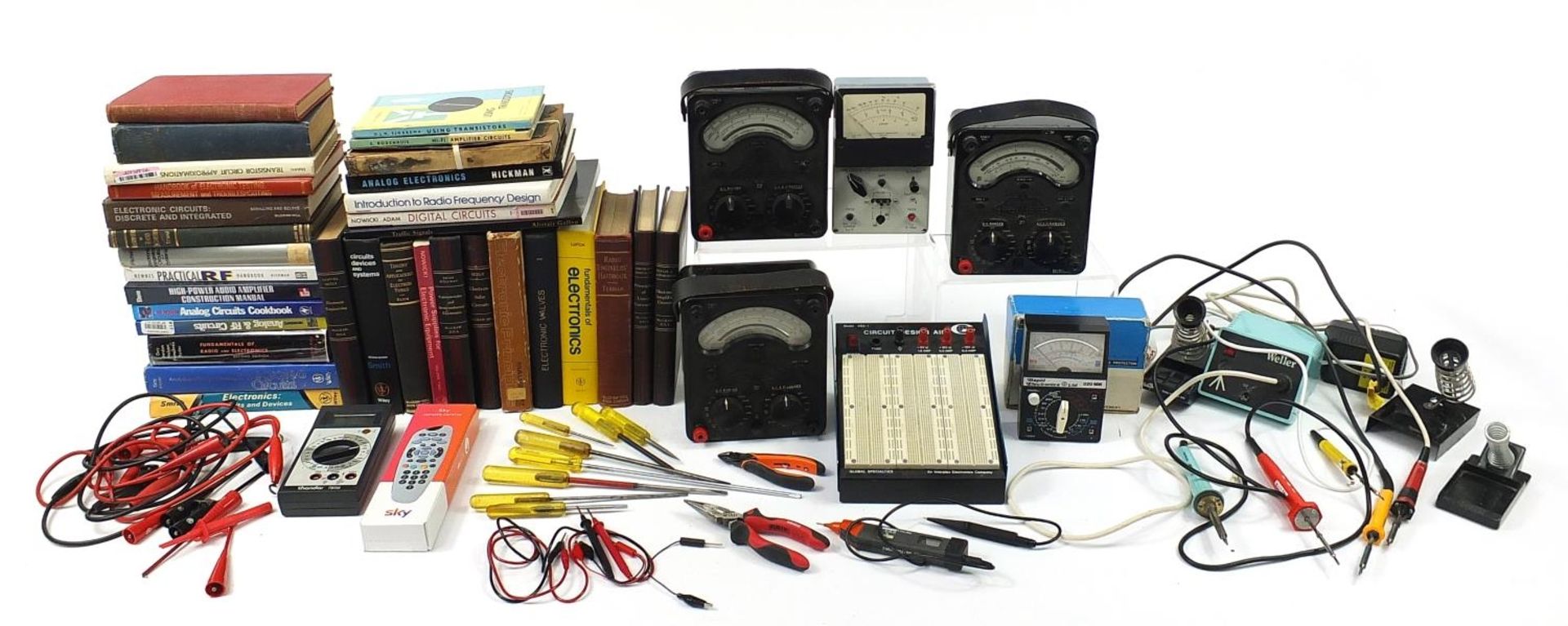 Collection of electrical voltage and circuit testing equipment and related books including Universal