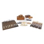 Group of chess pieces and Dominoes including carved soapstone and turned wood examples, the