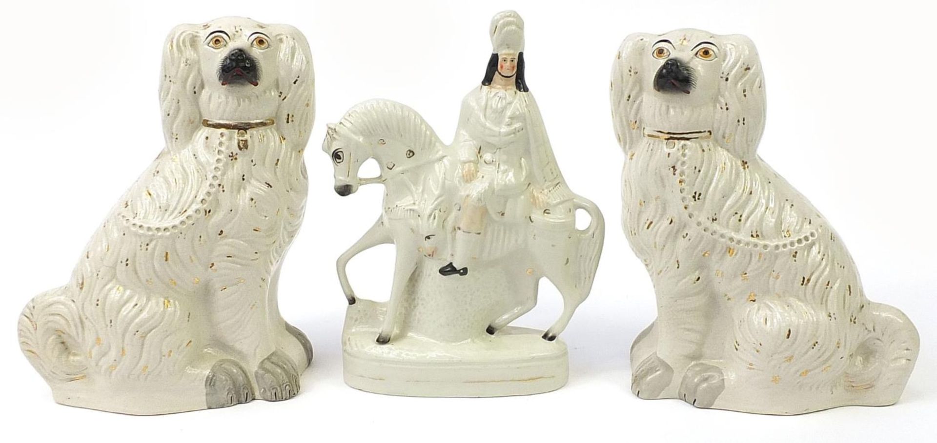 Staffordshire style flatback figure on horseback and a pair of seated Spaniels, the largest 36.5cm