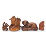 Four Japanese carved wood netsukes including a dog and elephant, the largest 5cm in length