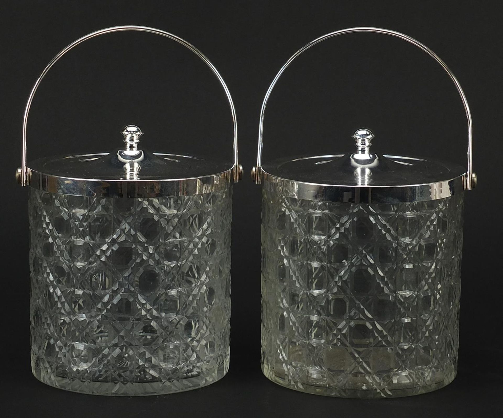 Pair of cut glass biscuit barrels with silver plated lids and swing handles, 15cm excluding the