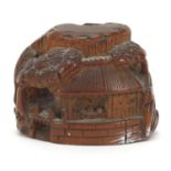 Japanese boxwood netsuke carved with figures in buildings and trees, 4cm in diameter