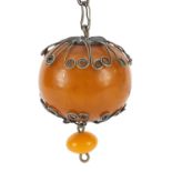 Large ethnic amber coloured bead with silver coloured metal mounts, the bead 5cm high, total 124.8g