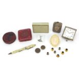 Objects including a silver plated vesta, Art Deco travel clock movement, ivorine badge and jewel