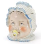 Continental porcelain baby's head tobacco jar and cover, 13cm high