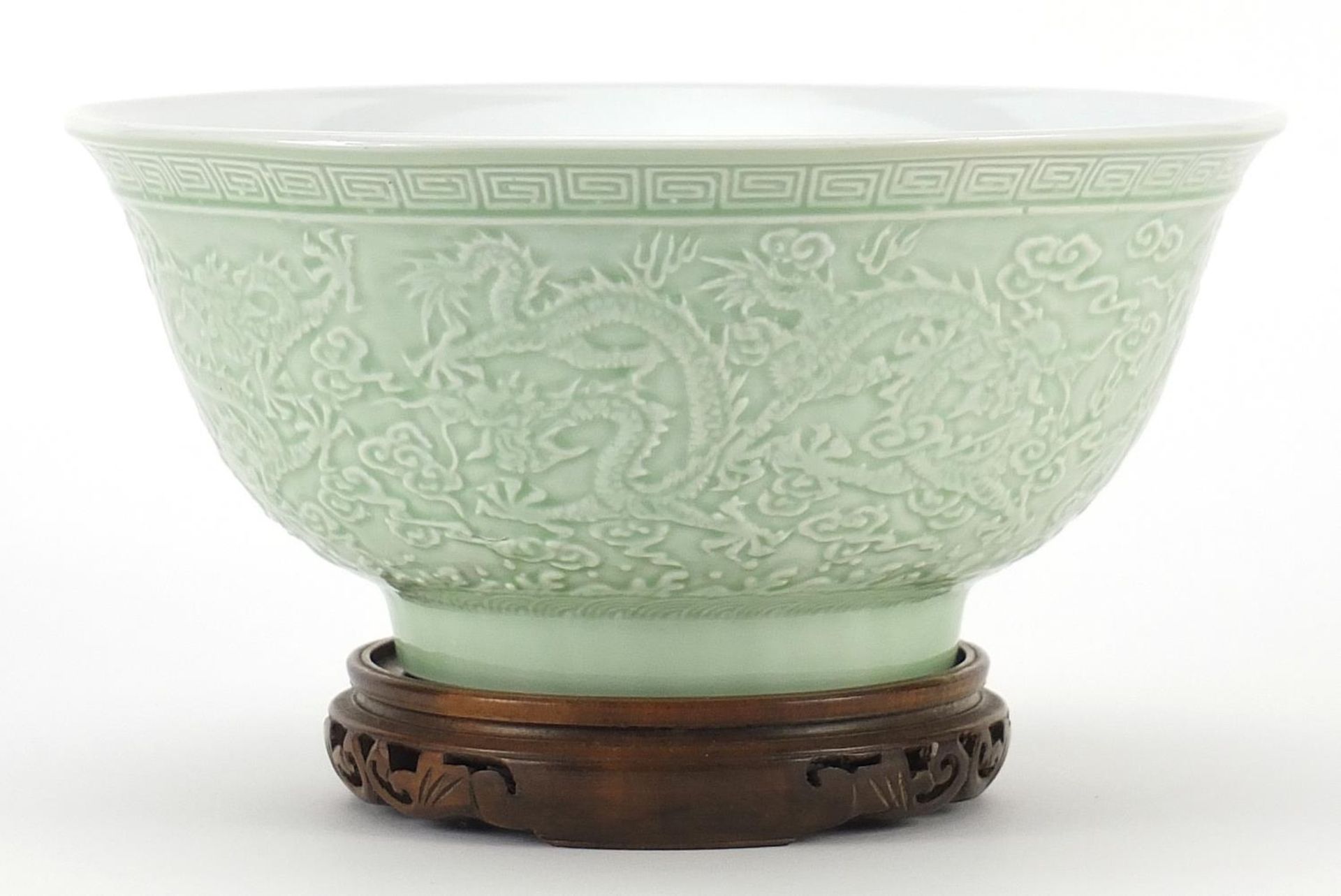 Chinese porcelain bowl raised on hardwood stand having a celadon glaze, decorated in relief with - Image 2 of 3