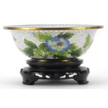 Chinese cloisonne bowl enamelled with butterflies amongst birds, the bowl raised on a carved