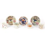 19th century porcelain comprising four coffee cans and three dishes, each hand painted with flowers,