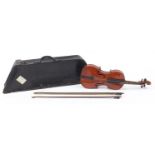 Old wooden violin with case and two bows, the violin bearing an Antonius, Stradinarius paper