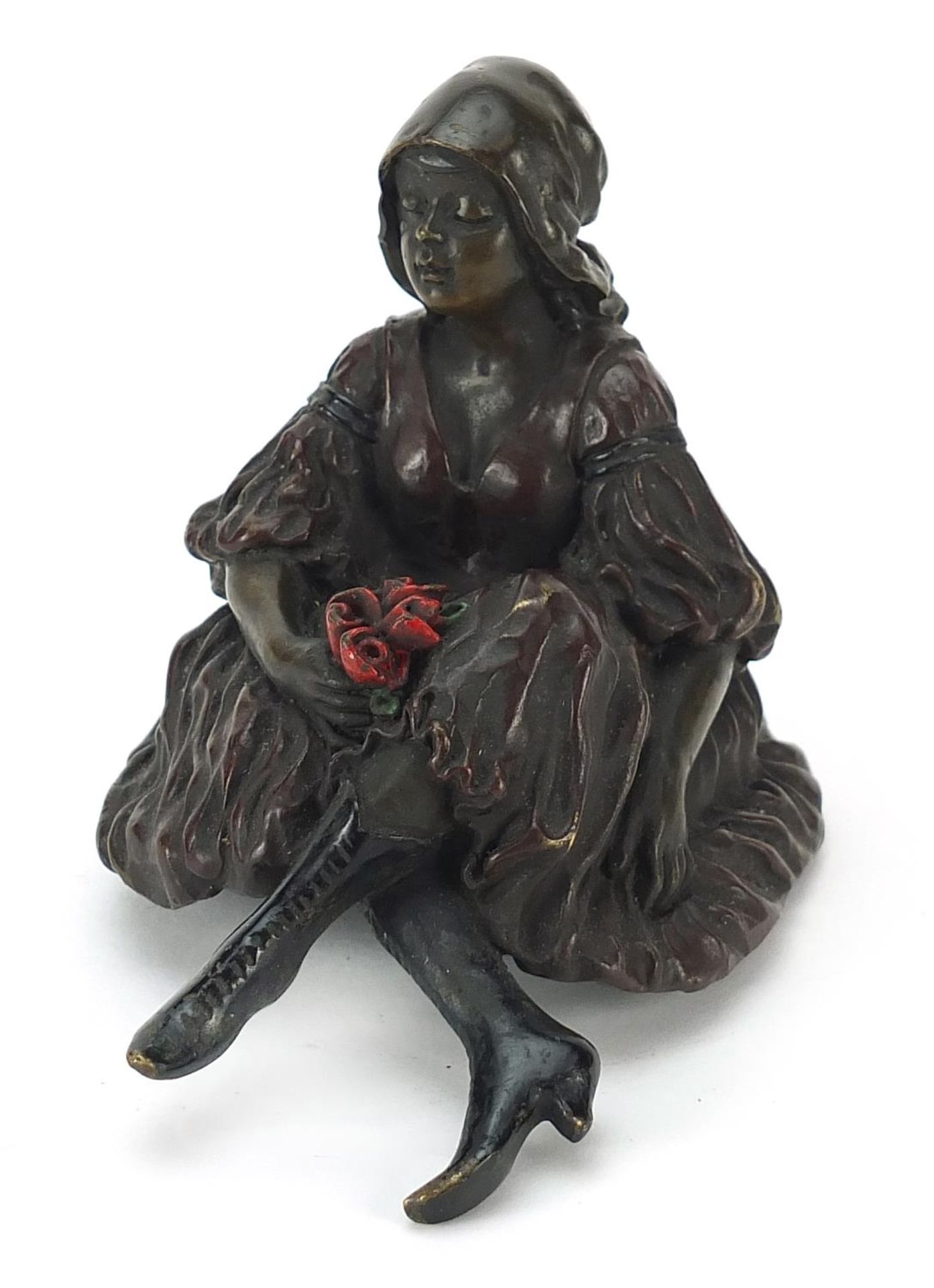 Cold painted bronze erotic figurine seated in a dress, 11cm in length