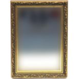 Ornate gilt framed wall hanging mirror with bevelled glass, 90cm x 65cm