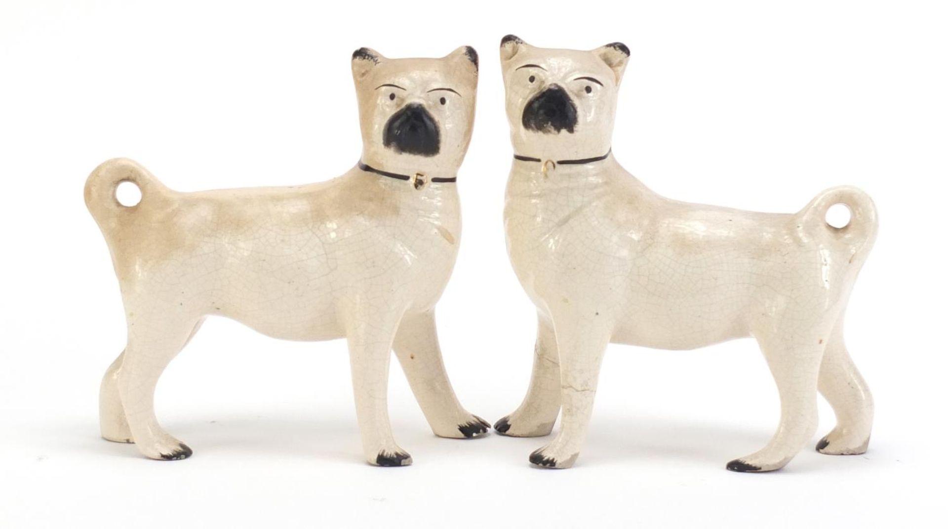 Pair of Staffordshire pottery pug dogs, each 15cm in length