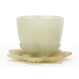 Indian pale green jade tea bowl with flower design saucer, the largest 5.5cm in diameter
