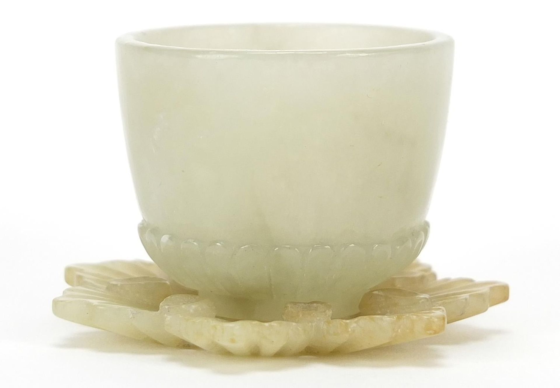 Indian pale green jade tea bowl with flower design saucer, the largest 5.5cm in diameter