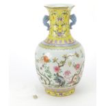 Chinese porcelain vase hand painted in the famille rose palette with flowers and scrolling