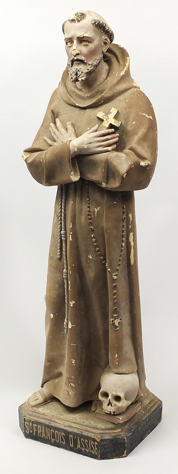 Large floor standing plaster figure of St Francois d'Assise raised on a painted wooden base, 137cm