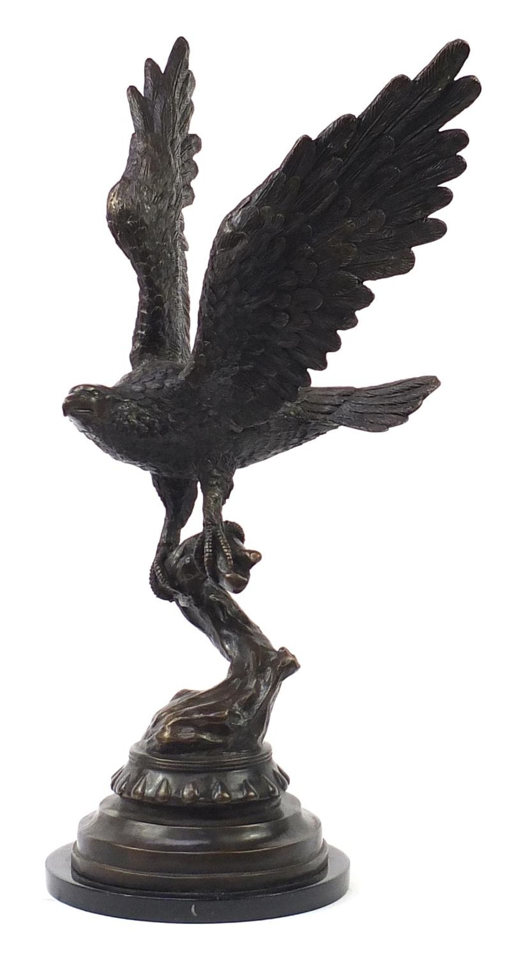 Floor standing patinated bronze study of an eagle with outspread wings raised on a circular black