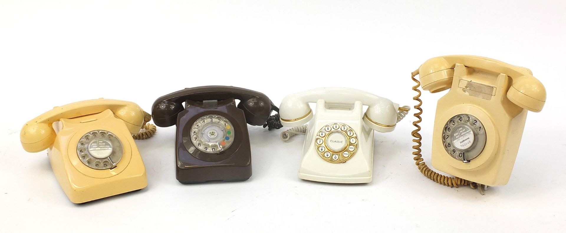 Four vintage dial telephones including two cream Bakelite examples