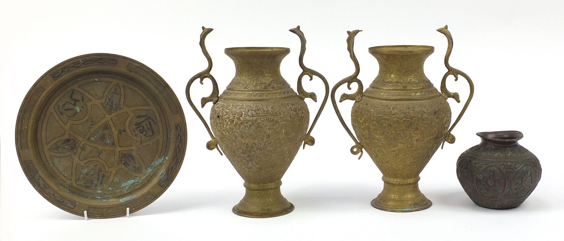 Indian and Middle Eastern metalware including a pair of vases with serpent handles decorated with