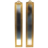 Pair of rectangular gilt framed mirrors with bevelled glass, each 121cm x 20cm