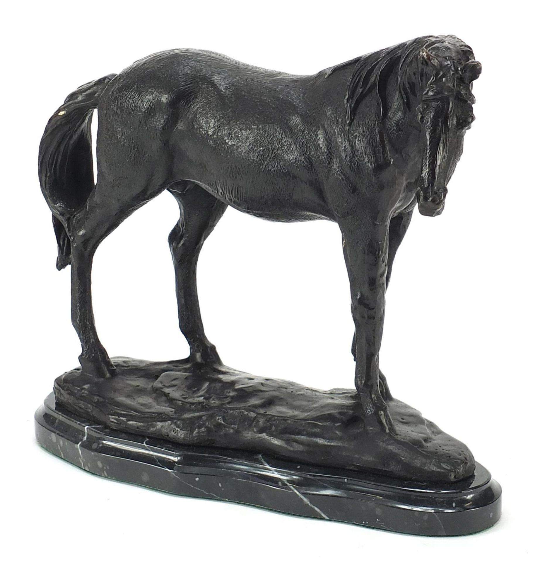 Patinated bronze study of a horse raised on a black marble base, 23cm high
