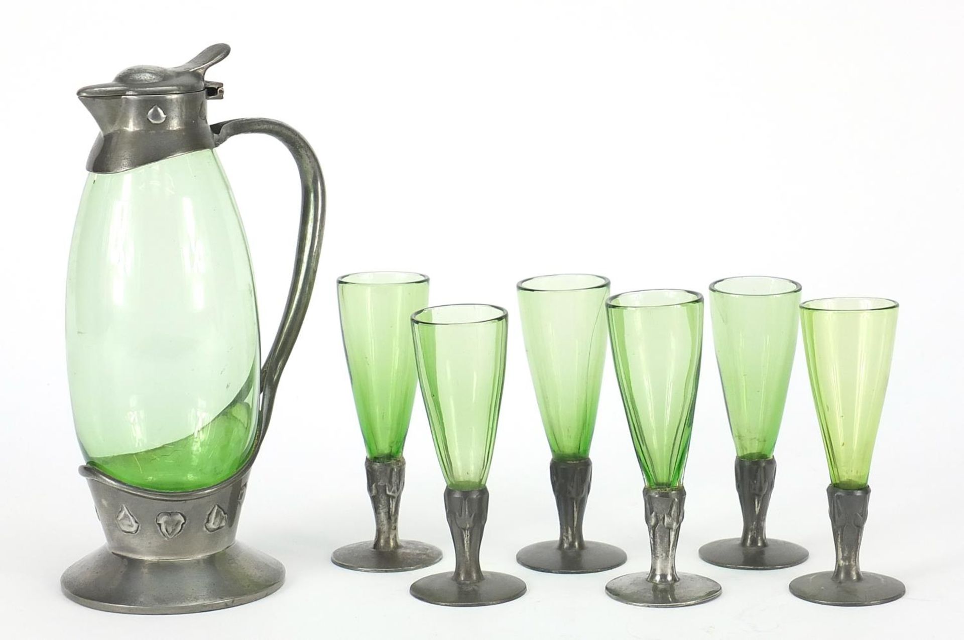 Archibald Knox for Liberty & Co, Arts & Crafts pewter and green glass liqueur set comprising jug and