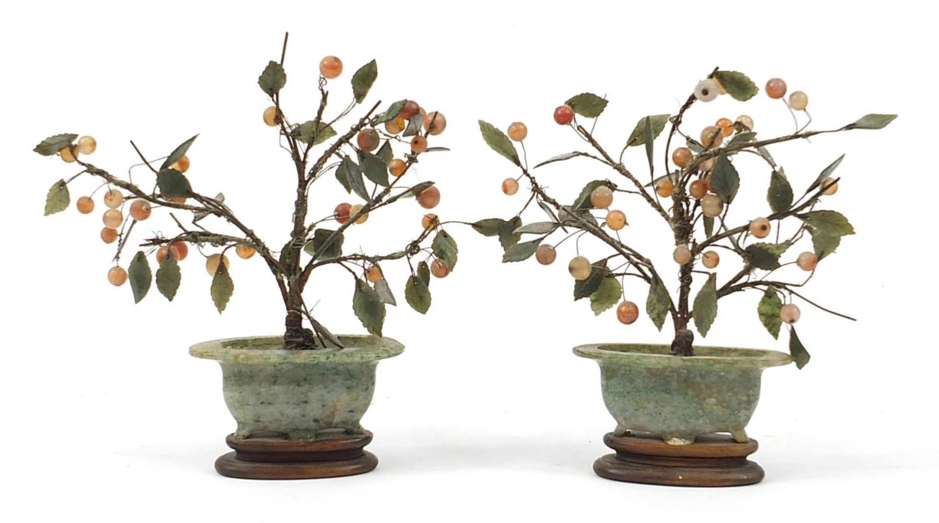 Pair of Chinese jade and hardstone bonsai trees raised on hardwood bases, the largest 20cm high