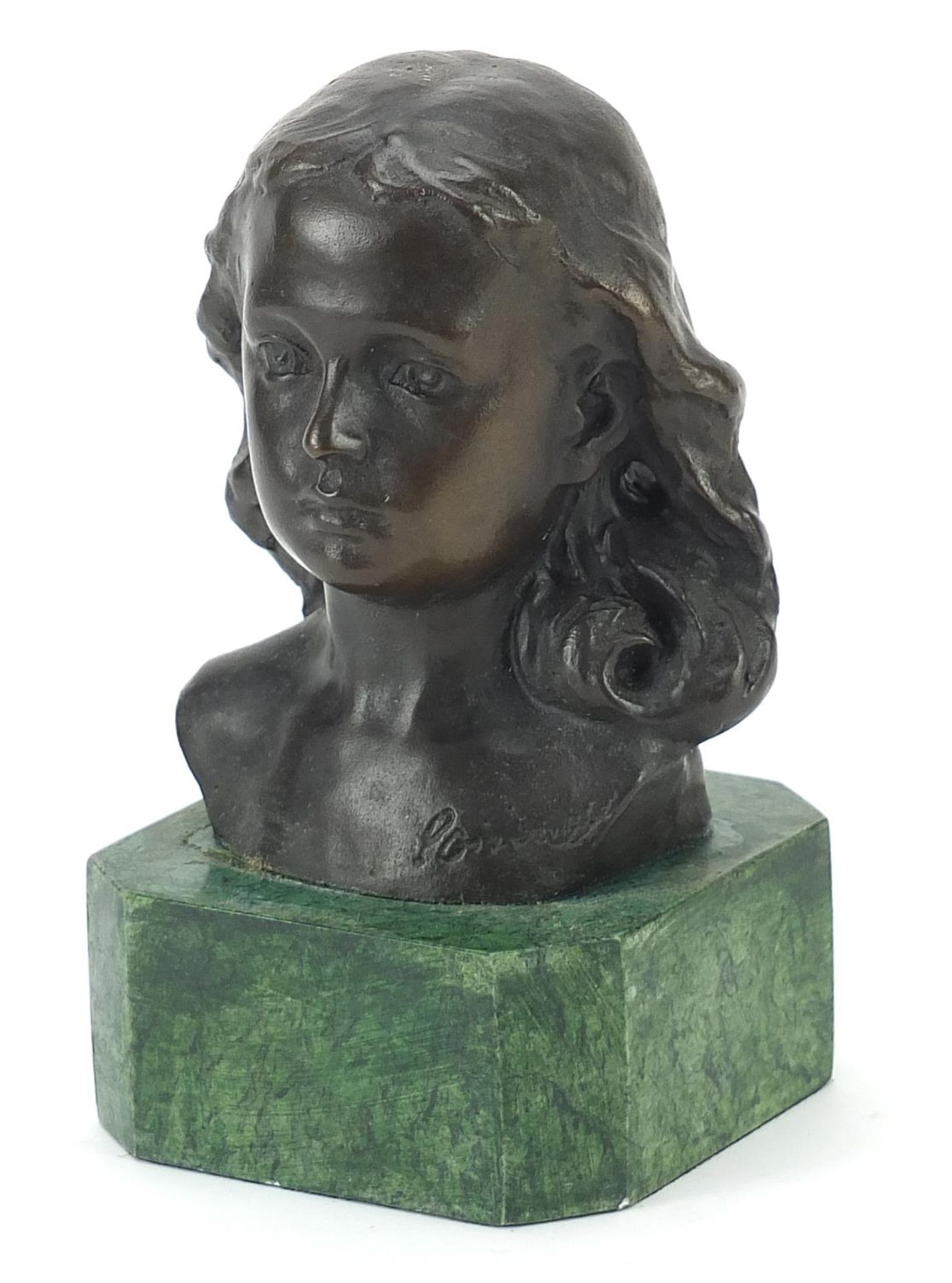 Patinated bronze head and shoulders bust of a young female raised on a green marbleised base, 15cm