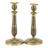 Pair of French Empire style bronze candlesticks decorated with flowers, each 29cm high