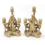 Pair of continental porcelain figural three branch candelabras by Plaue, each 26cm high