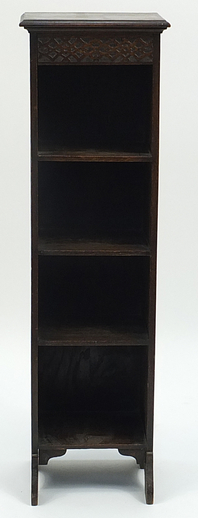 Slim oak bookcase with blind fretwork frieze, 104cm H x 30cm W x 22cm D