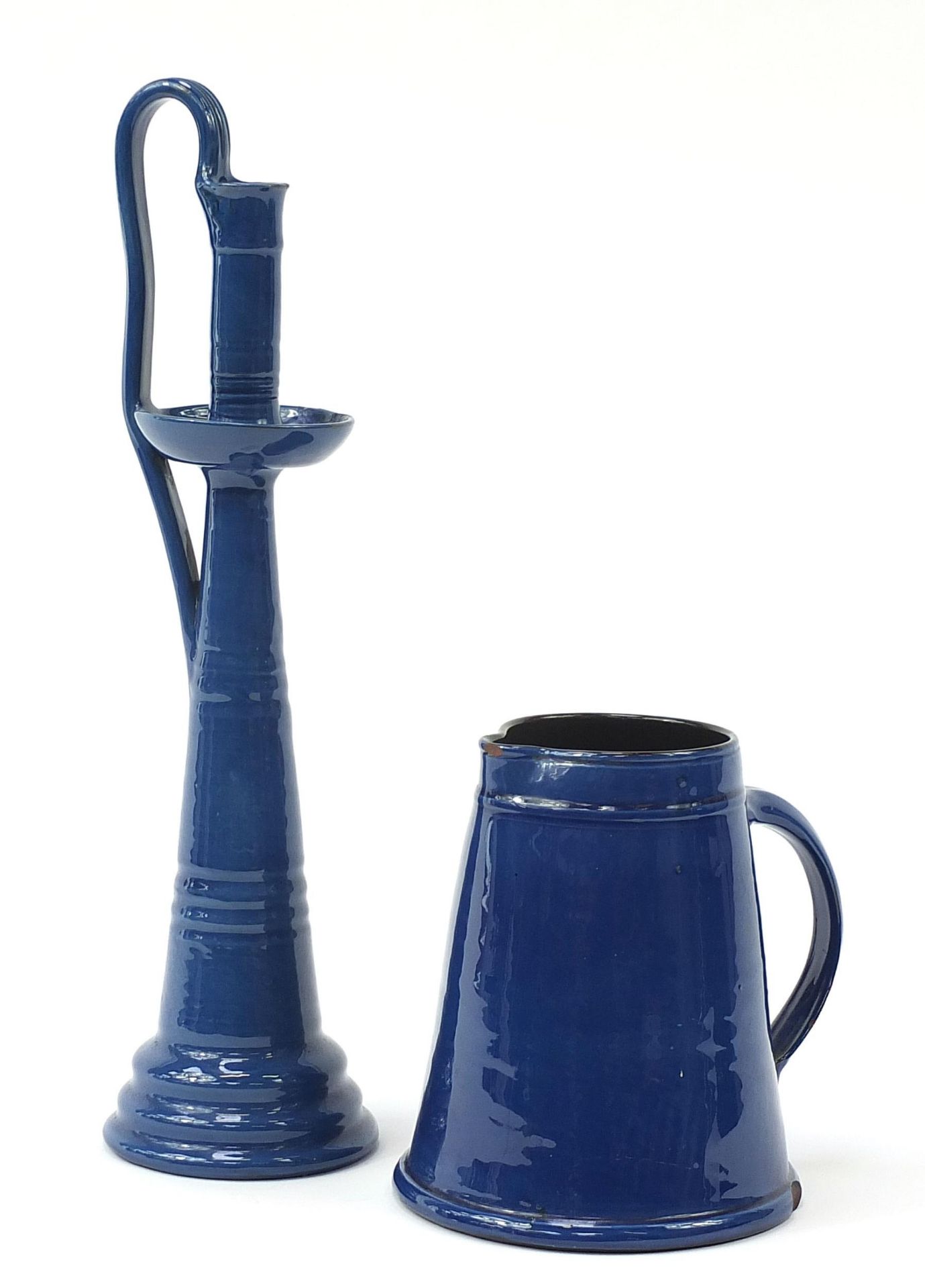 C H Brannam pottery blue glazed jug and a similar candlestick, the largest 44cm high