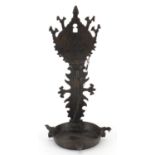 Antique Islamic bronze oil lamp engraved with flowers, 35cm high