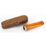 9ct gold mounted butterscotch amber cheroot holder with case, 5.2cm in length