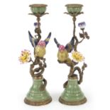 Pair of continental porcelain and bronze candlesticks in the form of birds amongst trees with