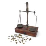 Set of Victorian mahogany and brass balance scales with weights, 26cm wide