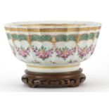 Samson porcelain bowl hand painted with flowers raised on a Chinese carved hardwood stand, the