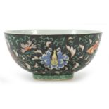 Chinese porcelain bowl hand painted in the famille noire palette with flower heads amongst scrolling