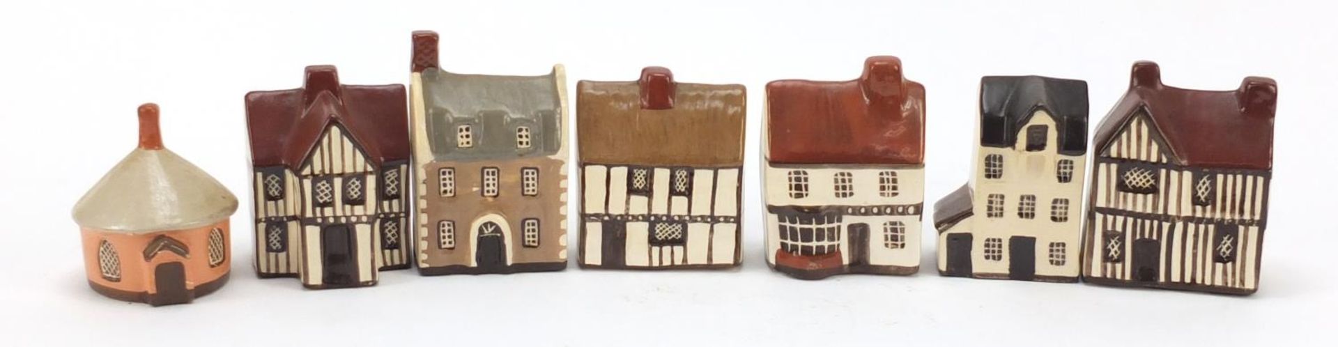 Seven Mudlen End Studio miniature cottages, the largest 9cm high