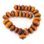 Large ethnic amber coloured bead necklace with white metal inlay to some of the beads, 60cm in