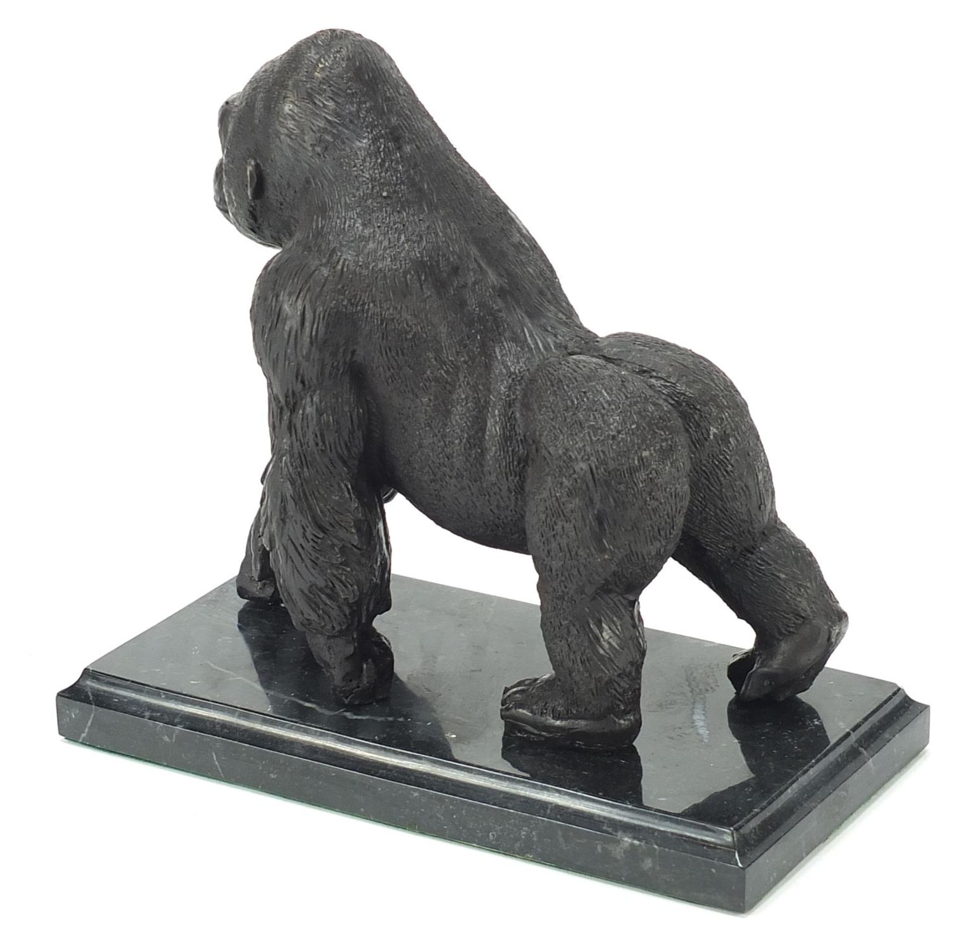 Patinated bronze gorilla raised on a black marble base, 20cm in length - Image 2 of 3